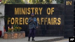 A police officer stands guard at the main entry gate of Pakistan's Ministry of Foreign Affairs in Islamabad.