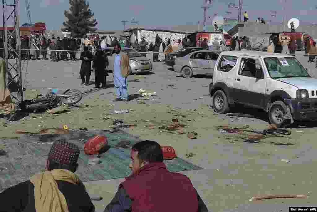 Security officials examine the scene of a bomb blast in Pakistan's Balochistan Province on February 7. Two bomb blasts killed more than 20 people and are raising concerns over security in the nuclear-armed South Asian country as it prepares for a general election.