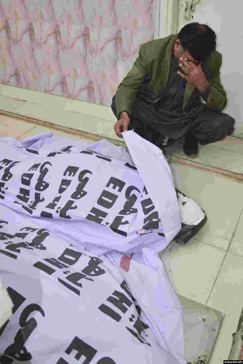 A man weeps after identifying the body of a relative. No group has claimed responsibility for either blast so far.