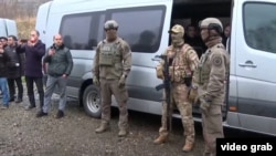 Azerbaijan - Azerbaijani officers escort Armenian POWs to the Armenian border, December 13, 2023.