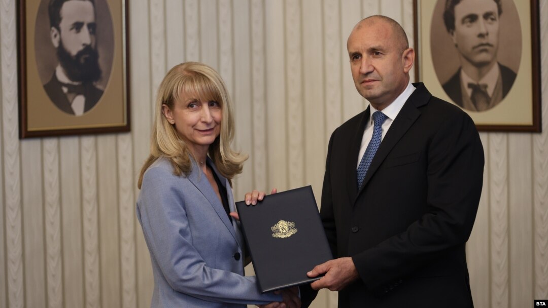 Bulgarian President Rumen Radev (right) hands a mandate to form a government to Goritsa Grancharova-Kozhareva in Sofia on August 9.