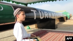 File photo of a Turkmen boy in traditional dress at an official launch ceremony of a gas pipeline project in 2010.