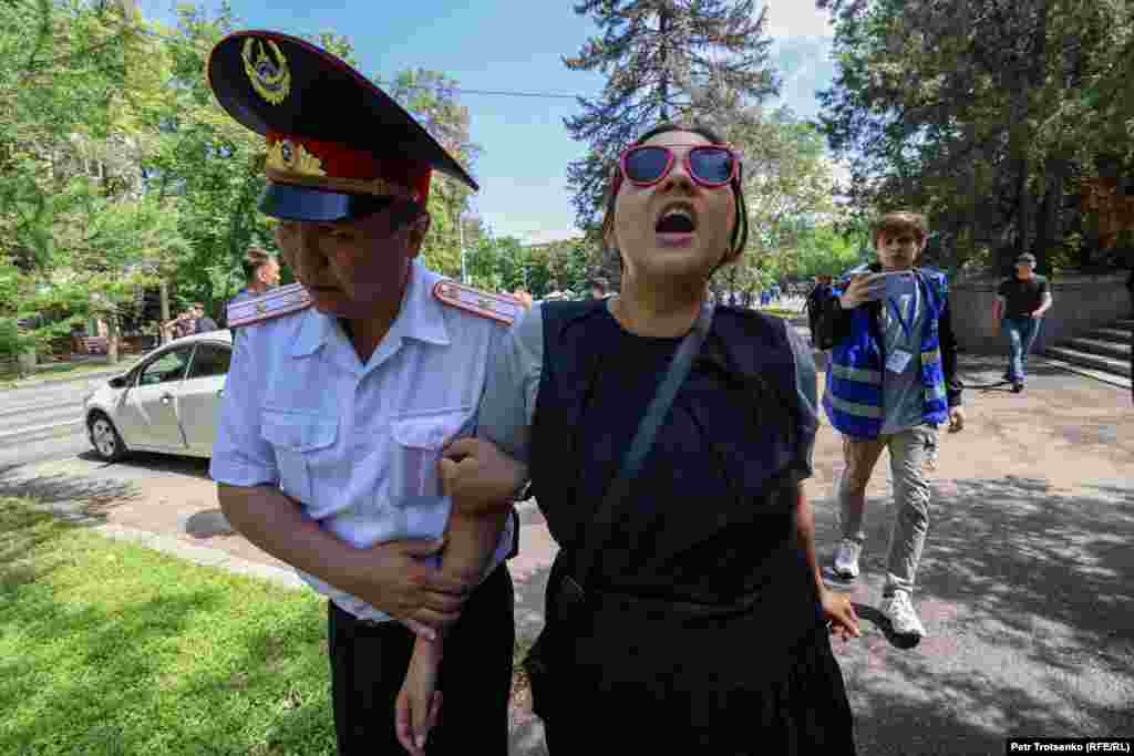 Сотрудники полиции задерживают активистку Асем Жапишеву. Алматы, 7 мая 2022 года