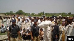 Displaced persons from South Waziristan receive rations in Pakistan's hard-hit Northwest Frontier Province