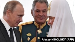 Kirill pátriárka Putyin elnökkel és Sojgu védelmi miniszterrel a haditengerészet napján Szentpétervárott 2017. július 30-án