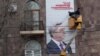 Armenia - Workers put up an election billboard of President Serzh Sarkisian in Yerevan, 21Jan2013.