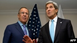 U.S. Secretary of State John Kerry (right) and Russian Foreign Minister Sergei Lavrov talk to reporters in Brunei on July 2.