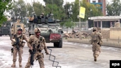 Canadian soldiers with NATO's International Security Assistance Force (ISAF) secure the site of multiple suicide bomb attacks outside the provincial council office in Kandahar in April 2009.