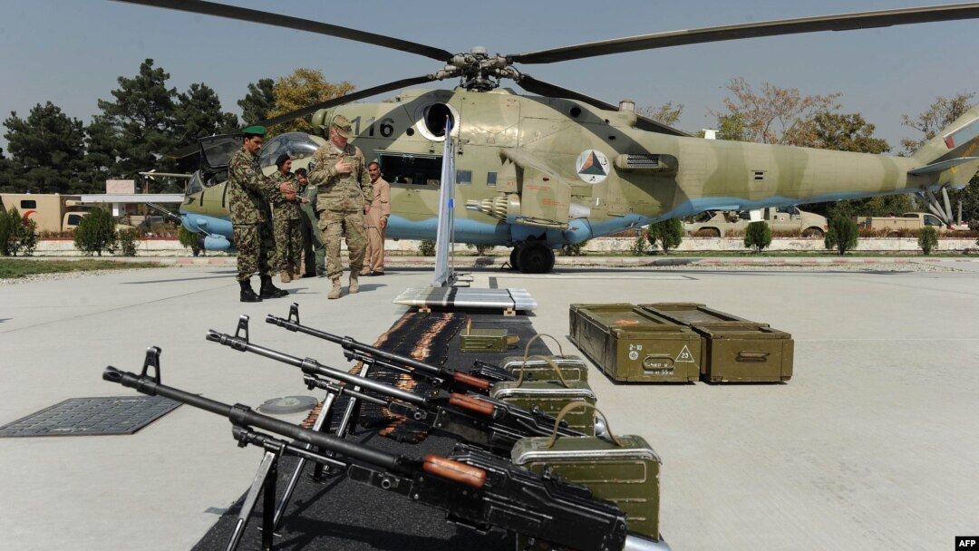 A U.S. soldier and Afghan National Army (ANA) soldiers at an exhibition of military equipment donated to the ANA by the United States and other countries at the Defense Ministry in Kabul in 2011.