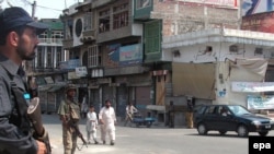 Soldiers stand guard on astreet in Mingora, in the Swat Valley.