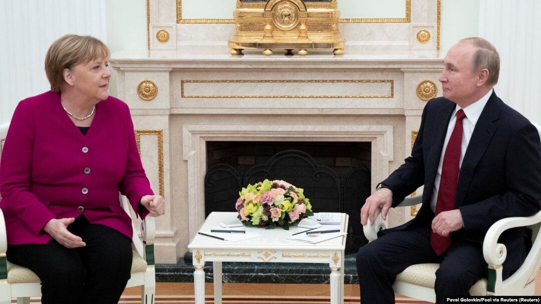 German Chancellor Angela Merkel and Russian President Vladimir Putin talk in the Kremlin on January 11. 