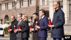 From left: Polish Prime Minister Donald Tusk, UK Prime Minister Keir Starmer, Ukrainian first lady Olena Zelenska, Ukrainian President Volodymyr Zelenskyy, French President Emmanuel Macron, and German Chancellor Friedrich Merz pay their respects to the victims of war at the Memorial for the Fallen in Kyiv on May 10,