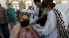 A woman receives a shot of the Sinopharm coronavirus vaccine from a health worker at a vaccination center in Karachi earlier this month. 