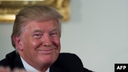 U.S. President Donald Trump smiles during a gala luncheon in Washington following his inauguration as the 45th President of the United States on January 20.