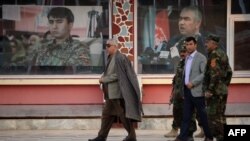 Afghan Vice President Abdul Rashid Dostum (L) walks at his headquarters in Sheberghan, capital of northern Jowzjan province in July 28.