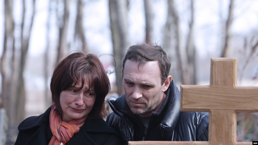 The parents of Maksim Mareyev, who was killed by one of the bombings in Moscow's subway on March 29, mourn at his funeral on March 31.