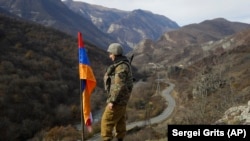 ARMENIA -- An ethnic Armenian soldier stands guard flag atop a hill in northwestern Karabakh, November 25, 2020