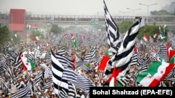 Supporters of opposition political parties wave party flags in Islamabad on November 1.