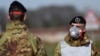 Italian Army soldiers wearing protective masks check transit to and from the cordoned areas in a check-point few kilometers from the small town of Castiglione d'Adda, southeast of Milan, on February 27, 2020 amid fears over the spread of the novel Coronav