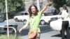Armenia -- Mariam Sukhudian, a civic activist charged with "false deninciation," greets supporters as she heads to a police station in Yerevan for interrogation on August 19, 2009.