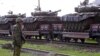 Georgia -- A Russian soldier patrols a military train loaded with tanks of 62nd base in Akhalkalaki at the railroad station of Tsalka some 120 km outside Tbilisi, 15 May 2006