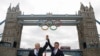 U.K. -- London Mayor Boris Johnson (L) and LOCOG Chairman Sebastian Coe pose for photos on a river boat under Tower Bridge after the the Olympic Rings were lowered into position for display in central London, 27Jun2012
