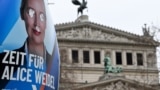 A defaced election campaign poster featuring a portrait of Germany's far-right Alternative for Germany (AfD) party co-leader and main candidate Alice Weidel is pictured in front of the Opera building in Frankfurt am Main, western Germany on February 14, 2