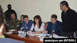 Nagorno Karabakh - Shahbaz Quliyev (R) and Dilham Askerov (third from L), Azerbaijani men charged by Karabakh's authorities with sabotage, stand before a court in Stepanakert, 27Oct,2014