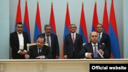 Armenia -- The ruling Republican Party and Armenian Revolutionary Federation sing a power-sharing agreement, Yerevan, 24Feb2016.