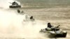 TRussian-built tanks roll under Tajik flags during Peace Mission 2012 joint counterterrorism military exercises of the troops from the six countries in the Shanghai Cooperation Organization in Khujand in June 2012.