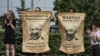 BELARUS -- Protesters hold the posters with Belarusian President Alyaksandr Lukashenka portraits standing near enter of the factory of refrigerators, freezers and washing machines Atlant and calling workers to join in strike and protests in Minsk, August 