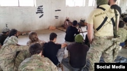 Photo from social media showing Uzbek militant and Liwa al-Muhajireen leader Abu Ubayda al-Madani lecturing militants in Syria.