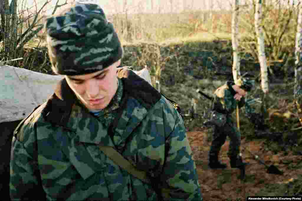 A recruit digs a hole for the officers' latrine.