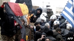 Greek demonstrators burn a German flag while trying to enter the parliament during an antiausterity protest in Athens.